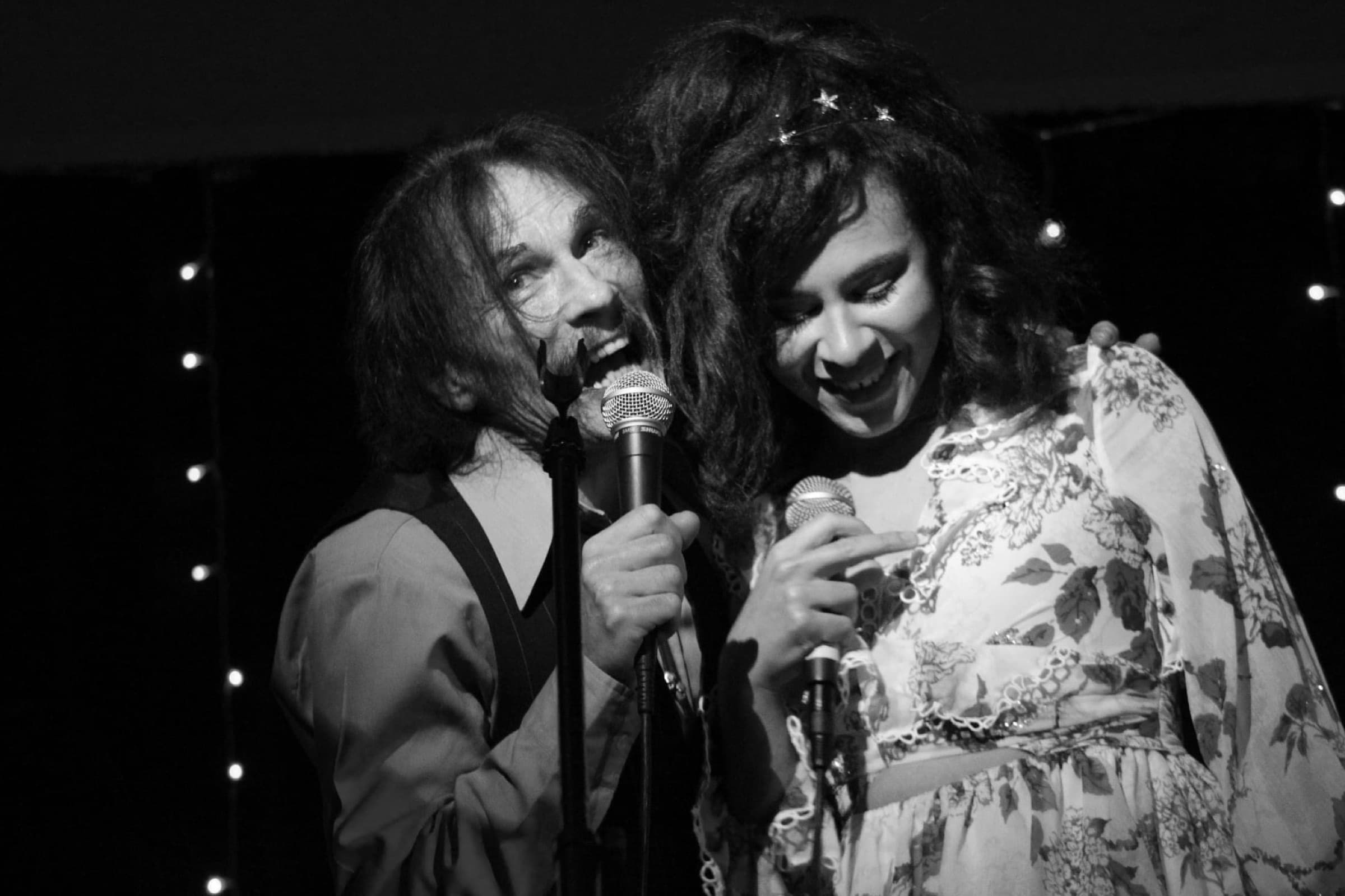 Tommy Scott (SPACE) & Satin Beige: black-and-white photograph of two singers sharing the front of the stage, microphones in hand